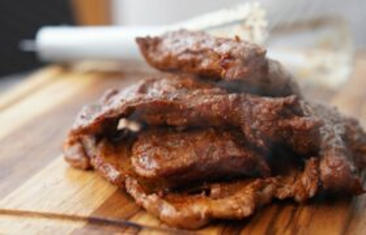 cooked meat on cutting board