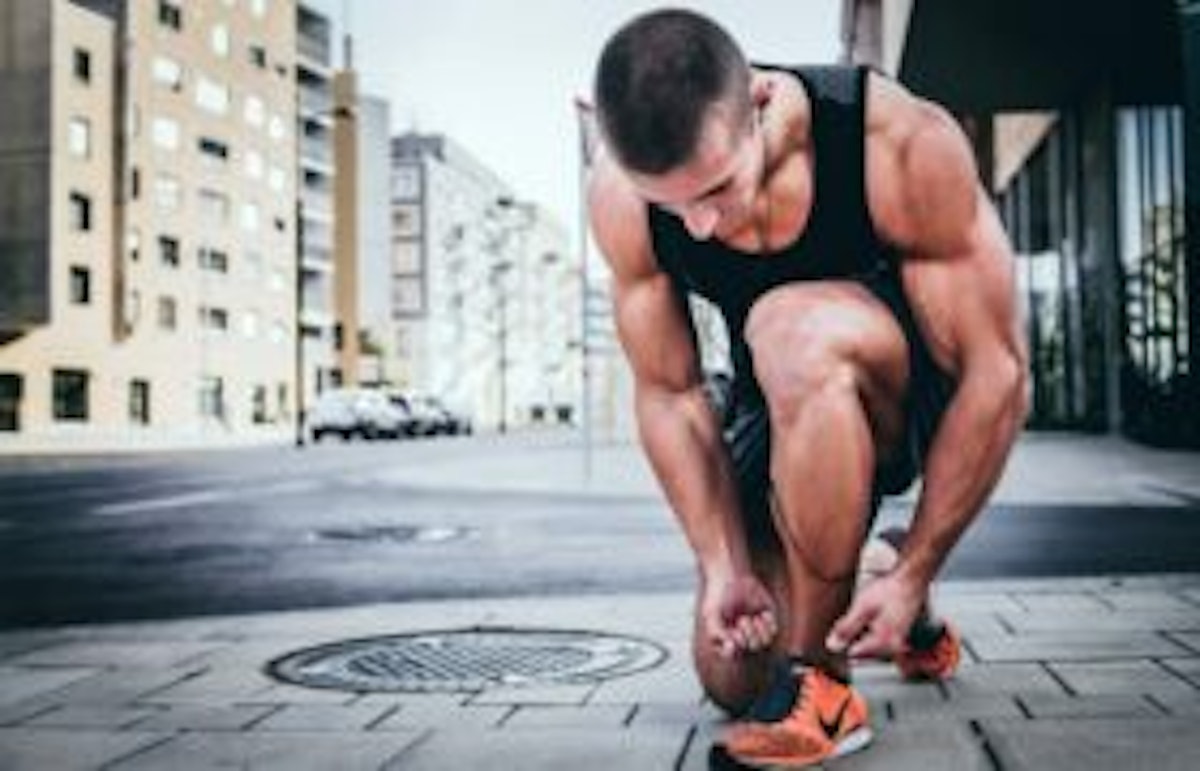 man tying shoes for workout