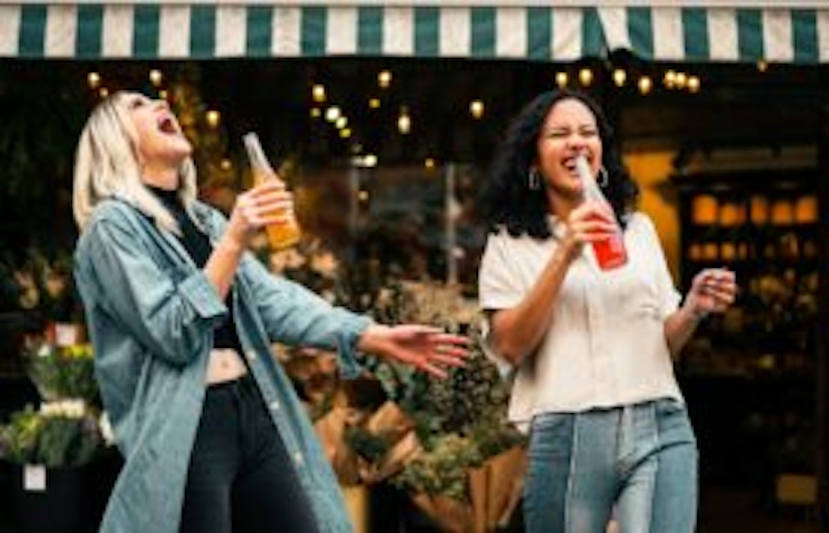 women holding soda