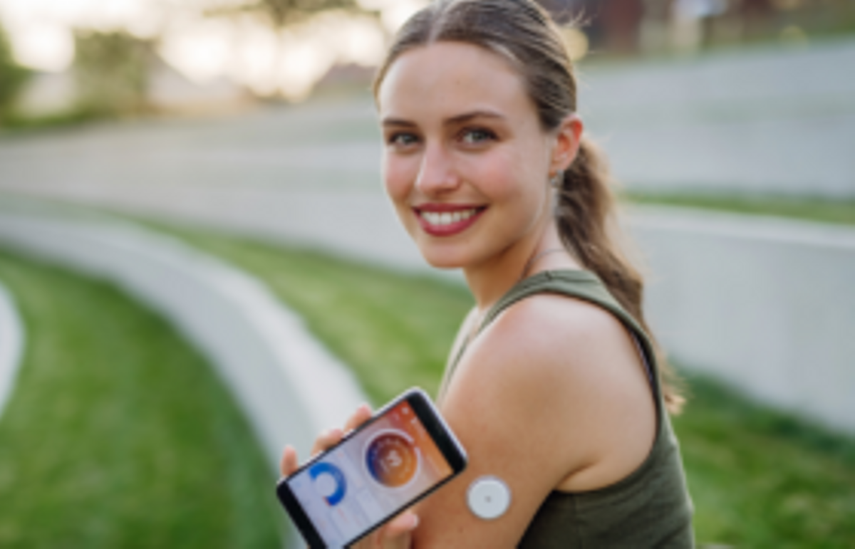 woman wearing cgm device