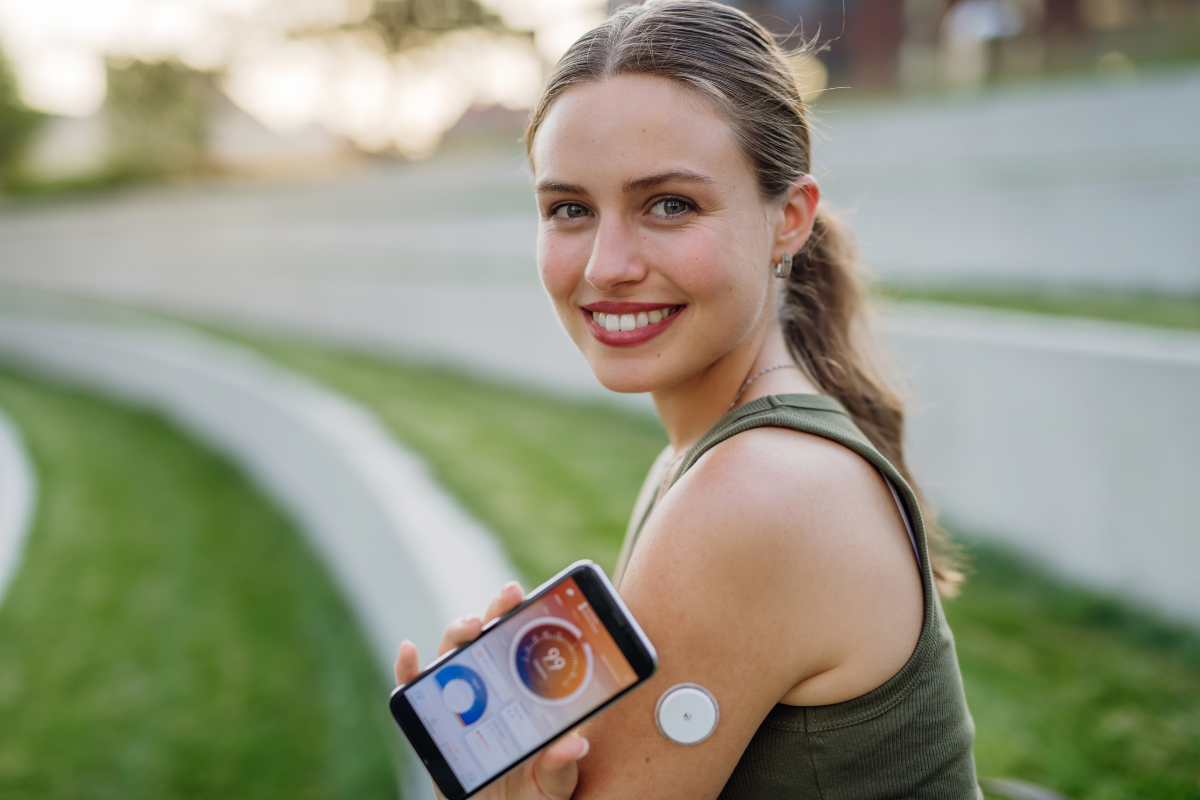 woman wearing cgm device